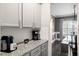 Kitchen countertop with granite countertops, grey cabinets, coffee maker, and pass through dining room at 301 Dunlin Dr, Summerville, SC 29486