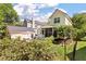 View of a backyard with an outdoor seating area, a screened porch and a lush lawn at 3023 Macbeth Creek Dr, Charleston, SC 29414