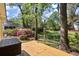A wood deck overlooks a well-manicured yard and lush greenery at 3023 Macbeth Creek Dr, Charleston, SC 29414