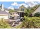 A beautiful backyard features a deck, a screened porch, and mature landscaping at 3023 Macbeth Creek Dr, Charleston, SC 29414