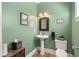 Charming powder room with green walls, pedestal sink, and tasteful decor at 3023 Macbeth Creek Dr, Charleston, SC 29414