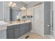 Stylish bathroom with double vanity, gray cabinets, and a decorative mirror and lighting at 3023 Macbeth Creek Dr, Charleston, SC 29414