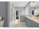 This contemporary bathroom boasts a glass shower and stylish vanity with neutral countertops and light gray cabinets at 3023 Macbeth Creek Dr, Charleston, SC 29414
