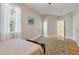 The room features a bed, a window with natural light, and an adjacent doorway leading to a connecting bathroom at 3023 Macbeth Creek Dr, Charleston, SC 29414