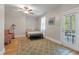 A comfortable bedroom with a ceiling fan, large rug, and access to an outdoor deck through a glass door at 3023 Macbeth Creek Dr, Charleston, SC 29414