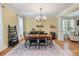 Bright dining room with a wooden table, black chairs, and a decorative ladder against the wall at 3023 Macbeth Creek Dr, Charleston, SC 29414