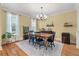 Cozy dining room with hardwood floors, area rug, table and chairs, and a view of the outdoor space at 3023 Macbeth Creek Dr, Charleston, SC 29414