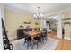Sunlit dining room featuring an elegant chandelier, table with seating, and hardwood floors at 3023 Macbeth Creek Dr, Charleston, SC 29414