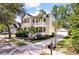 Attractive two-story home with a double porch, lush landscaping, and detached garage at 3023 Macbeth Creek Dr, Charleston, SC 29414