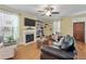 Cozy living room with a fireplace, built-in shelves, and large windows with natural light at 3023 Macbeth Creek Dr, Charleston, SC 29414