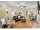 Inviting living room features hardwood floors, a ceiling fan, and a comfortable leather sofa at 3023 Macbeth Creek Dr, Charleston, SC 29414