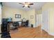 The well lit office includes two work stations, multiple windows, hardwood floors and a ceiling fan at 3023 Macbeth Creek Dr, Charleston, SC 29414