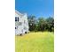 Large grassy backyard is perfect for outdoor activities, with trees in the distance at 3025 Dewitt Ct, Hollywood, SC 29449