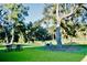Expansive backyard featuring a patio dining set, relaxing Adirondack chairs, shady trees, and a pond view at 3025 Dewitt Ct, Hollywood, SC 29449