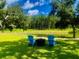 Picturesque backyard featuring lush lawn, serene pond view, and Adirondack seating area at 3025 Dewitt Ct, Hollywood, SC 29449