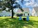 Spacious backyard with lawn, mature tree, patio and backyard seating area at 3025 Dewitt Ct, Hollywood, SC 29449