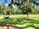 Inviting backyard with mature trees, water feature, and relaxing Adirondack chairs at 3025 Dewitt Ct, Hollywood, SC 29449