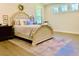 Bright bedroom featuring a decorative rug, light colored walls, and an elegant, upholstered bed with a decorative wreath at 3025 Dewitt Ct, Hollywood, SC 29449