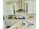 Bright kitchen featuring white cabinets, subway tile backsplash, and stainless steel appliances at 3025 Dewitt Ct, Hollywood, SC 29449