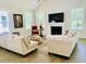 Cozy living room featuring neutral decor, fireplace, vaulted ceiling, and ample natural light at 3025 Dewitt Ct, Hollywood, SC 29449