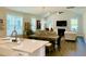 Bright and airy living room with dining area, a fireplace, lots of windows and hardwood floors at 3025 Dewitt Ct, Hollywood, SC 29449