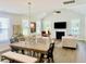 Open floor plan with a dining area that features hardwood floors and a vaulted ceiling at 3025 Dewitt Ct, Hollywood, SC 29449