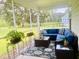 Inviting screened porch with comfortable L-shaped seating, potted plants, a glass table, and green lawn views at 3025 Dewitt Ct, Hollywood, SC 29449