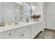 Bright bathroom featuring double sinks, quartz countertop, and a decorative flower arrangement at 309 Torslanda Ln, Summerville, SC 29486