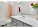 Bright bathroom features a shower-tub combo, white vanity with solid surface counter and large mirror at 309 Torslanda Ln, Summerville, SC 29486