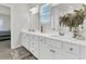 Bathroom with white cabinets, double sinks, and well-lit vanity mirrors at 309 Torslanda Ln, Summerville, SC 29486