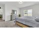 Inviting bedroom with a wooden bed frame and dresser; naturally lit from the window at 309 Torslanda Ln, Summerville, SC 29486
