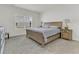 Bright bedroom with a large window, wooden bed frame, and soft carpeting at 309 Torslanda Ln, Summerville, SC 29486