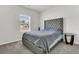 Bedroom with plush grey carpet and upholstered headboard features natural light from the window at 309 Torslanda Ln, Summerville, SC 29486