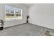 Sunlit bedroom with plush gray carpet and large window to the neighborhood at 309 Torslanda Ln, Summerville, SC 29486