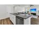 Kitchen island with granite countertops and stainless steel dishwasher in an open space at 309 Torslanda Ln, Summerville, SC 29486