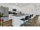 Stylish kitchen with white cabinetry, granite counters, stainless appliances, and bar seating overlooking the living area at 309 Torslanda Ln, Summerville, SC 29486