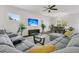 Bright, open living space features a sectional sofa, ceiling fan, and a view into the dining area at 309 Torslanda Ln, Summerville, SC 29486