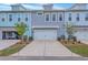 Colorful townhome exteriors with attached garages, well-maintained landscaping, and a welcoming curb appeal at 3119 Sturbridge Rd, Mount Pleasant, SC 29466