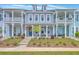 Charming townhomes boast double porches, inviting curb appeal, and classic architectural details at 3119 Sturbridge Rd, Mount Pleasant, SC 29466