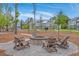 Inviting outdoor firepit area with seating and nearby hammocks surrounded by townhomes on a sunny day at 3119 Sturbridge Rd, Mount Pleasant, SC 29466