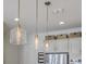 Pendant lights illuminate the gray cabinets and stainless steel appliances in this modern kitchen at 3119 Sturbridge Rd, Mount Pleasant, SC 29466