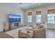 Bright living room with large windows, comfortable seating, and a stylish entertainment center at 3119 Sturbridge Rd, Mount Pleasant, SC 29466