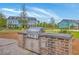 Outdoor kitchen featuring built-in grill and counter space in a sunny residential neighborhood at 3119 Sturbridge Rd, Mount Pleasant, SC 29466