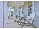 Inviting front porch with rocking chairs and classic architectural details at 3119 Sturbridge Rd, Mount Pleasant, SC 29466