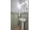 Charming powder room featuring stylish wallpaper, wainscoting, and a pedestal sink, offering a delightful space at 3119 Sturbridge Rd, Mount Pleasant, SC 29466