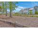 Well-manicured community features two-story townhomes, green lawns, and beautiful trees on a sunny day at 3119 Sturbridge Rd, Mount Pleasant, SC 29466