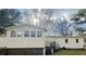 Exterior view showcasing the home's design with multiple windows and an elevated deck area at 334 E Poplar Branch Dr, Moncks Corner, SC 29461