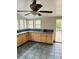 Well-lit kitchen featuring ample counter space, wood cabinets, and tiled flooring at 334 E Poplar Branch Dr, Moncks Corner, SC 29461