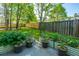 Landscaped backyard with a garden, grass, and a wooden fence on a sunny day at 3363 Kinross Ct, Summerville, SC 29485