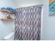 A bathroom showcasing a shower with decorative curtain and rustic shelves displaying towels and soaps at 3363 Kinross Ct, Summerville, SC 29485
